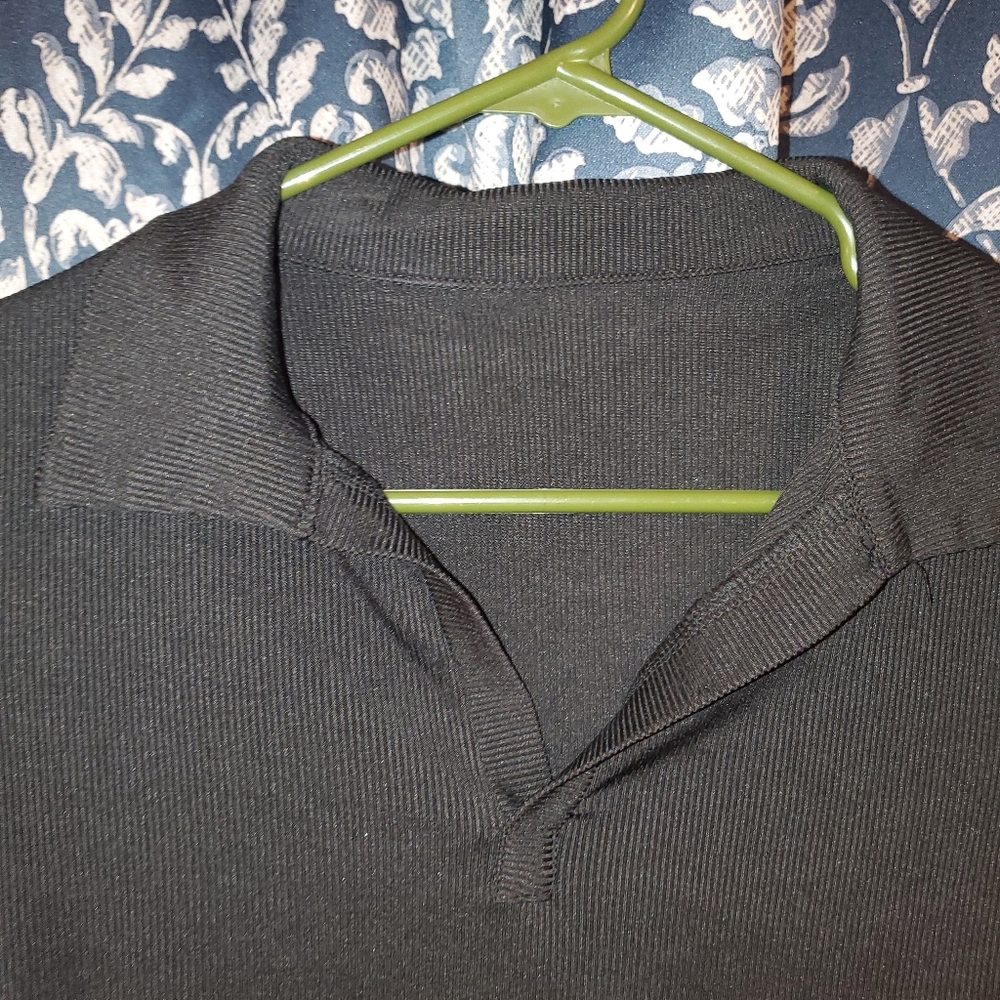 Small, black, polo shirt.